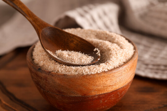 Bowl with psyllium husk powder on table, closeup