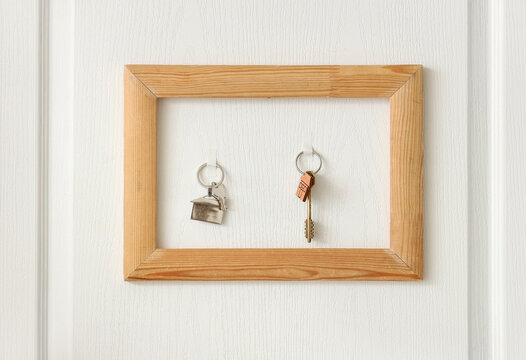 Frame with keys hanging on door in hallway, closeup
