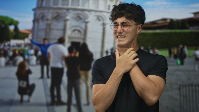 Man clutching neck with hand on throat in front of pisa tower building on crowded street tourist site; distress.