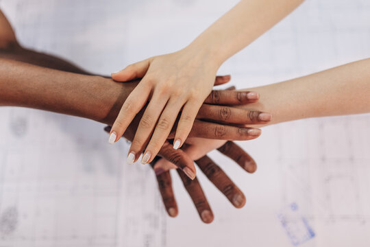 Diverse hands stacked in unity for teamwork and support