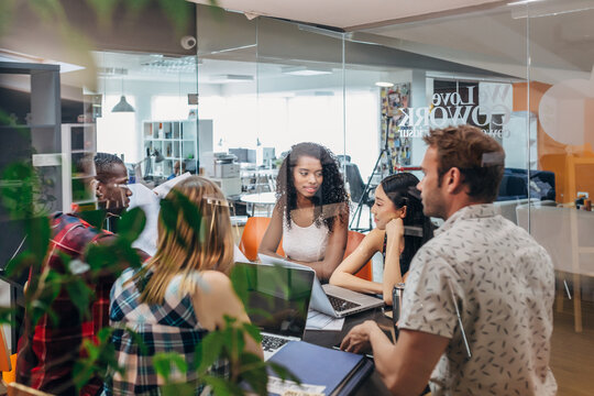 Diverse startup team meeting in modern glass office room