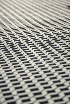 Abstract repeating metal grid pattern with geometric industrial texture background.