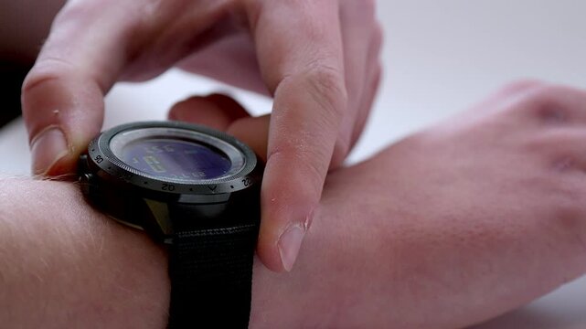 Man Operating Digital Wristwatch with Beeping Sound and Display Interaction

