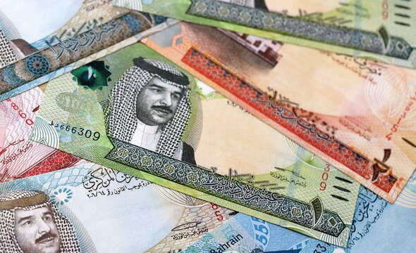Bahraini dinar money bills pile on table. Bahrain banknotes of BHD currency close up.