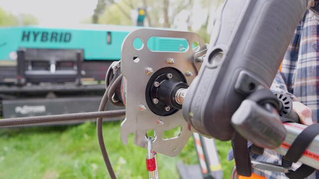 Close-up of tool attachment on metal plate near hybrid truck