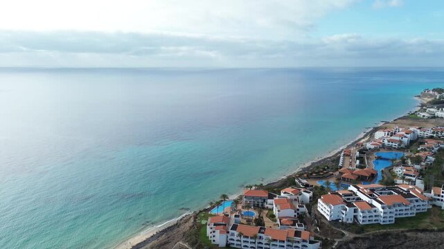 Aerial panorama of luxury oceanfront resort with blue swimming pools at Costa Calma, Fuerteventura
