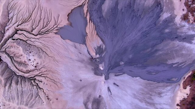 Aerial view of the unique geological formations of the Vulcanii Noroiosi Paclele Mici mud volcanoes with grey mud flows and cracked earth Scortoasa, Buzau County, Romania.