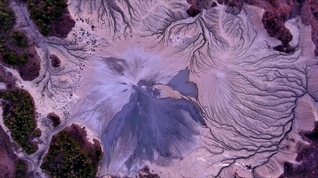 Aerial view of Vulcanii Noroiosi Paclele Mici mud volcanoes with unique erosion patterns and grey mud flows in Scortoasa, Buzau County, Romania.