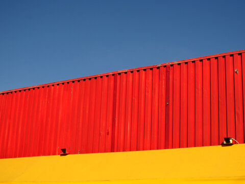 Red, Yellow and Blue Simplicity with Urban Street Cargo Container, Wall and Sky