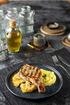 Grilled pork chop with mashed potatoes and cauliflower steak