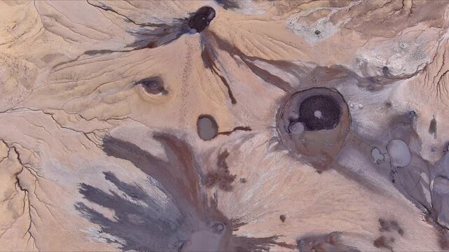 Aerial view of Vulcanii Noroiosi Paclele Mici mud volcanoes with unique craters and dried mud flows in Scortoasa, Buzau County, Romania.