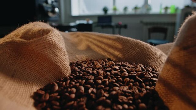 Closeup of roasted coffee beans in burlap sack for packaging background.