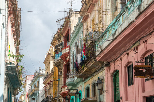 Cuba, Havana.  Street facing apartments and shops.