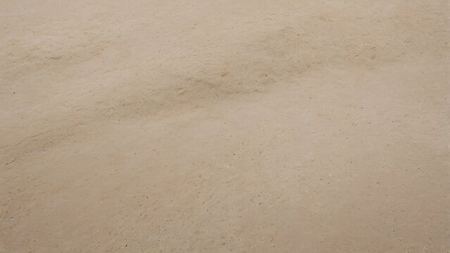 Abstract beige concrete textured surface with natural sand and grit details.