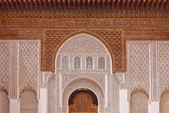 Lavishly carved wood and richly sculpted stucco, NW facade housing the screen doorway to the Ben Youssef Madrasa courtyard. Marrakesh-Morocco-316