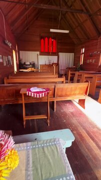 A Holy Bible rests on a stack of books on a table in Whangamomona, Manawatu-Whanganui, New Zealand.. The image evokes a sense of peace and reflection.