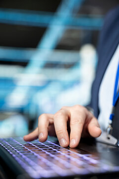 Typing on laptop, IT infrastructure and close up of programmer upgrading autonomous server room rigs. Writing on keyboard, notebook device and software developer updating server farm systems
