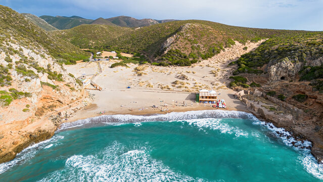 Aerial view of the turquoise waters and limestone cliffs of Cala Domestica beach in Buggerru, Sardinia, Italy