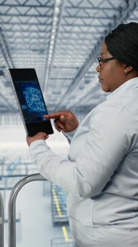 Vertical video Using AI deep learning, EDA software and woman monitoring PCB smart factory workflow. Tracking microchip production, artificial intelligence simulation and African american female