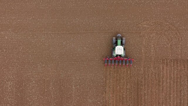 Aerial view tractor seeding corn rows sustainable Italy farming