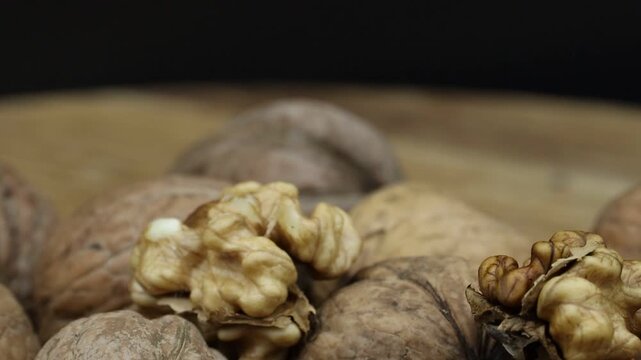 Rotating macro video of brown walnuts highlighting their health benefits.