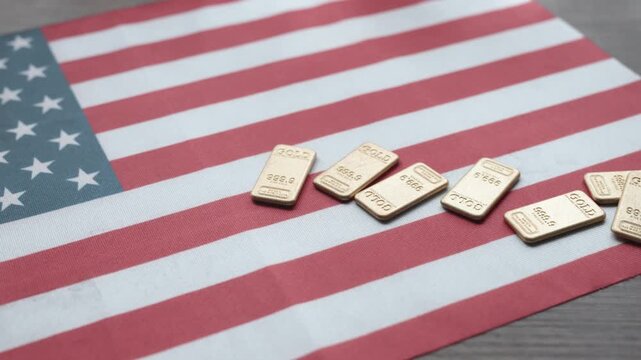Gold Bars on American Flag Close-up - USA Wealth and Economy Concept