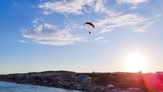 paragliding sky flying drone travel aerial sport vacation beach coastline view coast water sea sunset evening skyline flight beauty business city urban - Guardamar del Segura, Alicante, Spain - 2025