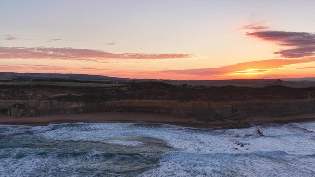 Gibson Steps and Port Campbell National Park, Great Ocean Road, Victoria, Australia at sunrise: 4K aerial drone footage of cliffs, beach, ocean waves and coastal landscape near Twelve Apostles.