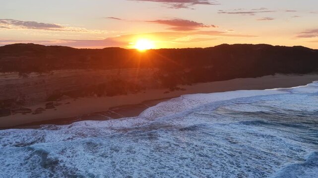 Gibson Steps and Port Campbell National Park, Great Ocean Road, Victoria, Australia at sunrise: 4K aerial drone footage of cliffs, beach, ocean waves and coastal landscape near Twelve Apostles.