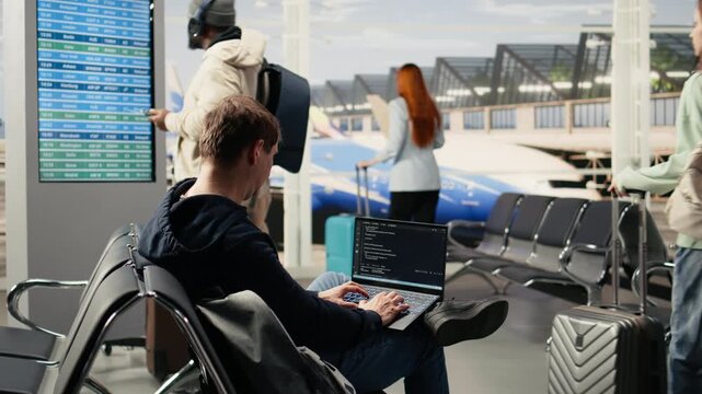 Independent developer, coding program, and reviewing binary data, laptop in the airport, waiting area highlights remote software engineering and the modern digital nomad lifestyle.