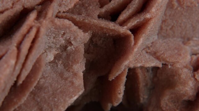 A macro of desert rose crystal or sand rose (a rose-like formations of crystal clusters of gypsum and sand grains)� isolated on a black background