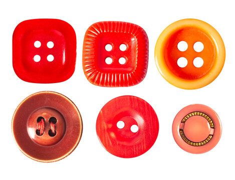 Isolated photo of orange and red colored cloth buttons on white backdrop.