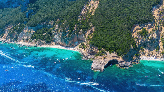 Aerial panorama of Cala dei Gabbiani and Cala Mariolu beaches with turquoise water and limestone cliffs, Gulf of Orosei, Baunei, Sardinia, Italy