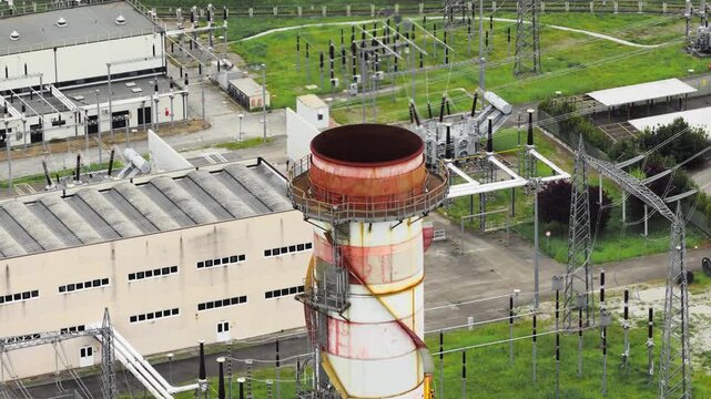 Aerial view of the Centrale Termoelettrica Santa Barbara Enel with its industrial chimney and electrical substation in Santa Barbara, Toscana, Italy.