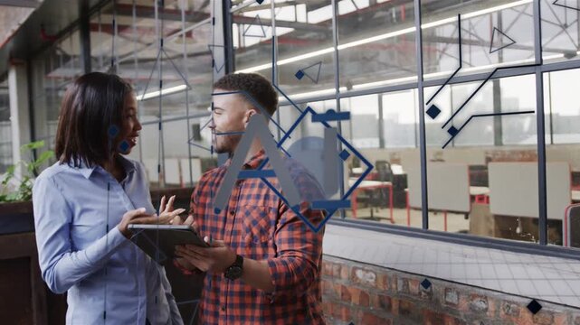 Woman explaining while man tapping tablet, showing moving chart rising over glass logo for business