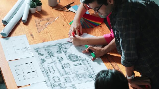 Close up of civil engineer hands holding and asking project manager about plan. Group of architect brainstorming and explaining blueprint while sitting at meeting table with project plan. Symposium.