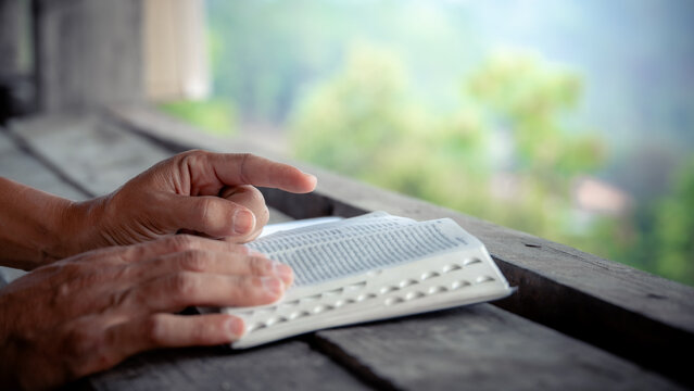 Close up of a man reading the Bible Spiritual concepts by studying the Holy Scriptures together, devotional concept