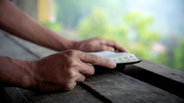 Close up of a man reading the Bible Spiritual concepts by studying the Holy Scriptures together, devotional concept