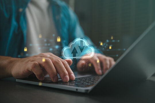 Close-up of hands typing on laptop with cloud computing interface, data transfer arrows and security locks, representing cybersecurity, cloud storage, digital network protection technology workflow.