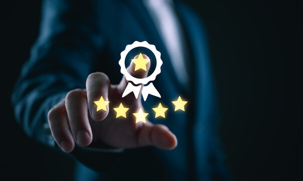 Businessman selecting five star rating with quality badge icon on virtual interface, customer satisfaction, service excellence, feedback evaluation, reputation management in digital business.