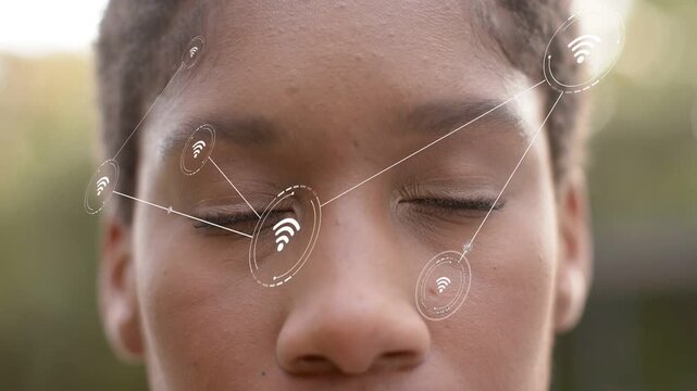 Woman holding eyes closed as Wi-Fi node appearing near eye, AR nodes expanding, showing facial scan