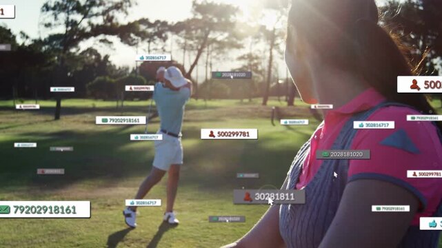Woman with golf bag watching male golfer starting swing, HUD labels tracking ball for golf analysis