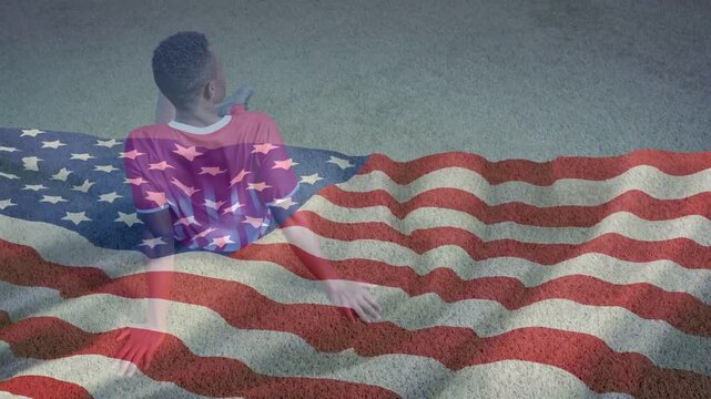 Man leaning back and sliding left-hand while looking off camera, flag overlay waving for marketing
