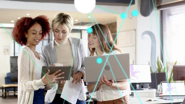 Three women tapping tablet and angling laptop, starting teal overlay over screens during business