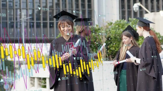 Graduate tapping phone holding diploma causing moving charts over group celebrating graduation
