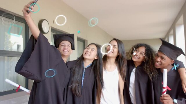 Left grad raising phone for graduation selfie, friends leaning in, confetti passing faces, fading