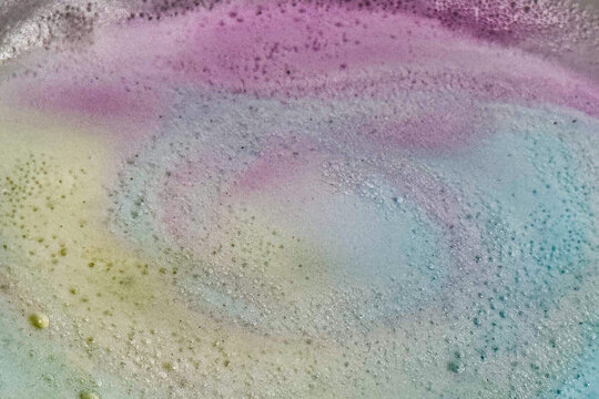 Bubbles produced by bath bombs creates colorful spacy background plate
