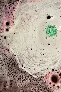 Sudsy bubbles from bath bombs produce colorful spacy background plate