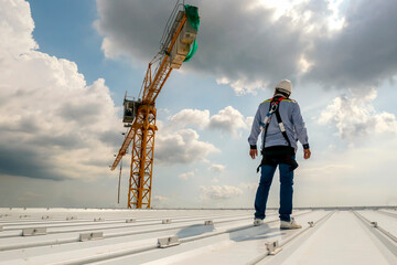 Construction engineer wear safety uniform inspection metal roofing work for roof industrial concept with copy space © Rassarin
