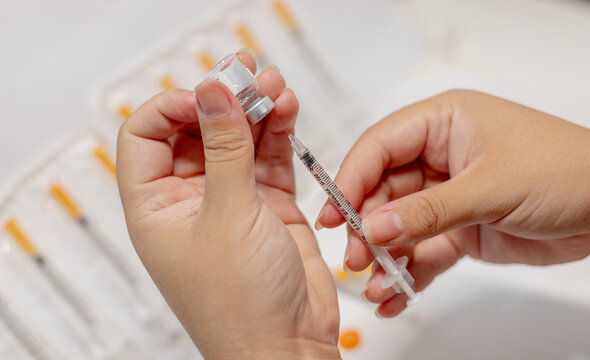 Vials of Tirzepatide medication and insulin syringes for weight loss and diabetes treatment.